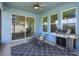 Enclosed patio with dining table, grill, blue walls and a sliding glass door leading inside at 6960 Audobon Osprey Cv, Harmony, FL 34773