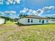 View of backyard with grass and bright sky at 701 Marion Oaks Trl, Ocala, FL 34473