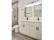 Modern bathroom with double sinks, quartz countertop, and a tiled glass shower at 701 Marion Oaks Trl, Ocala, FL 34473