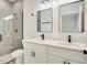 Elegant bathroom with double vanity, sleek mirrors, quartz countertop and a tiled shower at 701 Marion Oaks Trl, Ocala, FL 34473