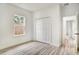 Bright bedroom features a window, closet and durable floors at 701 Marion Oaks Trl, Ocala, FL 34473