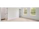Bright bedroom with two windows, light wood floors and closet for ample storage at 701 Marion Oaks Trl, Ocala, FL 34473