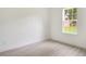 Minimalist bedroom with light wood floors and a window bringing in natural light at 701 Marion Oaks Trl, Ocala, FL 34473