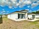 An exterior view of a modern single-story home with tidy landscaping and a well-manicured lawn at 701 Marion Oaks Trl, Ocala, FL 34473