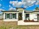 Charming single-story home featuring a modern design, decorative shutters, and a beautifully landscaped front yard at 701 Marion Oaks Trl, Ocala, FL 34473