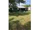 Spacious backyard featuring green grass and view of the back of house with screened in back porch at 710 W Swoope W Ave, Winter Park, FL 32789