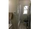 Cozy bathroom featuring a tub with shower, a window, and neutral tiling at 710 W Swoope W Ave, Winter Park, FL 32789