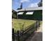 Charming home featuring a dark green exterior, metal roof, fenced yard and white window awnings at 710 W Swoope W Ave, Winter Park, FL 32789
