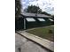 Charming home featuring a dark green exterior, metal roof, fenced yard and white window awnings at 710 W Swoope W Ave, Winter Park, FL 32789