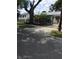 Landscaped front yard with decorative pavers and black iron fence surrounding a large tree at 710 W Swoope W Ave, Winter Park, FL 32789