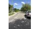 Residential street view with mature trees, utility poles, and a truck parked on the side of the street at 710 W Swoope W Ave, Winter Park, FL 32789
