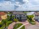 Stunning aerial view of a luxury home with beautiful landscaping, circular driveway, and waterfront access at 711 Windlass Ct, Kissimmee, FL 34746