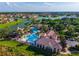 Stunning aerial view showcasing the community pool, clubhouse, and surrounding waterfront properties at 711 Windlass Ct, Kissimmee, FL 34746