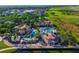 Aerial view of the community pools, clubhouse, and manicured landscaping on a sunny day at 711 Windlass Ct, Kissimmee, FL 34746