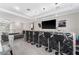 Contemporary bar area featuring black bar stools, a textured wall panel, and a sleek granite countertop at 711 Windlass Ct, Kissimmee, FL 34746