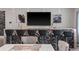 Entertainment bar with black bar stools, a large TV, and textured wall paneling behind the stunning granite countertop at 711 Windlass Ct, Kissimmee, FL 34746