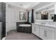 This bathroom features a soaking tub, an illuminated mirror over the vanity, and a separate shower room at 711 Windlass Ct, Kissimmee, FL 34746