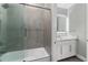 Modern bathroom featuring a shower-over-tub, gray wall tiles, and a vanity with ample counter space at 711 Windlass Ct, Kissimmee, FL 34746