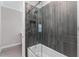 Contemporary bathroom boasts a tub-shower with gray tiling, and sleek fixtures for a modern aesthetic at 711 Windlass Ct, Kissimmee, FL 34746