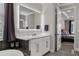 The bathroom features a large illuminated mirror over double sinks and a view to the bedroom at 711 Windlass Ct, Kissimmee, FL 34746