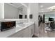 Modern bathroom with a sleek vanity, a large mirror, and neutral finishes at 711 Windlass Ct, Kissimmee, FL 34746