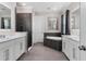Spacious bathroom featuring double vanities, a soaking tub, and a walk-in shower at 711 Windlass Ct, Kissimmee, FL 34746