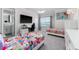 Inviting bedroom boasts two twin beds, a sleek TV, a gaming desk, and a well-lit area for work or study at 711 Windlass Ct, Kissimmee, FL 34746