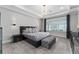 Main bedroom with modern chandelier, bench, and bedside tables at 711 Windlass Ct, Kissimmee, FL 34746