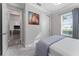 This bedroom offers a closet, window with blinds and curtains, and an adjacent room at 711 Windlass Ct, Kissimmee, FL 34746