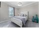 This bedroom offers a bed, large window with blinds and gray curtains, and a modern light fixture at 711 Windlass Ct, Kissimmee, FL 34746