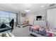 Bright bedroom featuring two twin beds, modern furnishings, gray walls, and ample natural light from a window at 711 Windlass Ct, Kissimmee, FL 34746