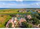 Community aerial view featuring clubhouse, pool, waterfront homes and beautiful Florida landscaping at 711 Windlass Ct, Kissimmee, FL 34746