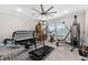 Home exercise room with large windows, various fitness equipment, and a fan at 711 Windlass Ct, Kissimmee, FL 34746
