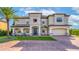 Stately two-story home with lush landscaping, a brick driveway, and a grand entrance at 711 Windlass Ct, Kissimmee, FL 34746