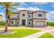 Stately two-story home with lush landscaping, a brick driveway, and a grand entrance at 711 Windlass Ct, Kissimmee, FL 34746