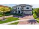 Beautifully landscaped two-story home with circular driveway and large front porch at 711 Windlass Ct, Kissimmee, FL 34746