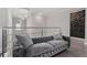 Hallway featuring a modern gray couch with decorative pillows, glass railings, and a stunning crystal chandelier at 711 Windlass Ct, Kissimmee, FL 34746