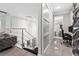Hallway with a decorative chandelier near staircase leading to an office area at 711 Windlass Ct, Kissimmee, FL 34746