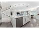 Stylish kitchen with modern island, stainless steel appliances, and staircase view at 711 Windlass Ct, Kissimmee, FL 34746