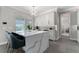 Bright kitchen island with white countertop, modern lighting, and seating at 711 Windlass Ct, Kissimmee, FL 34746