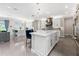 Open-concept kitchen with white cabinetry, stainless steel appliances, and adjacent living area at 711 Windlass Ct, Kissimmee, FL 34746