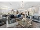 Spacious living room with modern lighting, open layout to kitchen, and stylish decor at 711 Windlass Ct, Kissimmee, FL 34746