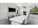 Bright office with a white desk, cozy seating, wall art, and a large TV creating an ideal workspace at 711 Windlass Ct, Kissimmee, FL 34746