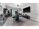 Home office space with a large black desk, built-in cabinets, and a wall-mounted television at 711 Windlass Ct, Kissimmee, FL 34746