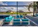 A luxurious outdoor seating area with comfortable turquoise furniture, a fire pit, and stunning water views at 711 Windlass Ct, Kissimmee, FL 34746
