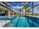The sparkling pool features mosaic tile accents and serene water views from under the screened-in lanai at 711 Windlass Ct, Kissimmee, FL 34746