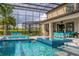 Beautiful screened-in pool area with a spa, outdoor kitchen, and comfortable seating, perfect for entertaining at 711 Windlass Ct, Kissimmee, FL 34746