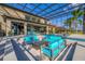 Spacious screened-in pool area with stylish seating and fire pit provides an ideal outdoor entertaining space at 711 Windlass Ct, Kissimmee, FL 34746