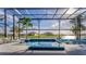 A gorgeous outdoor screened in pool overlooking the waterfront adds a resort style touch to this Florida home at 711 Windlass Ct, Kissimmee, FL 34746