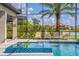 Relax by the elegant pool with integrated spa and beautiful water views from the screened-in lanai at 711 Windlass Ct, Kissimmee, FL 34746